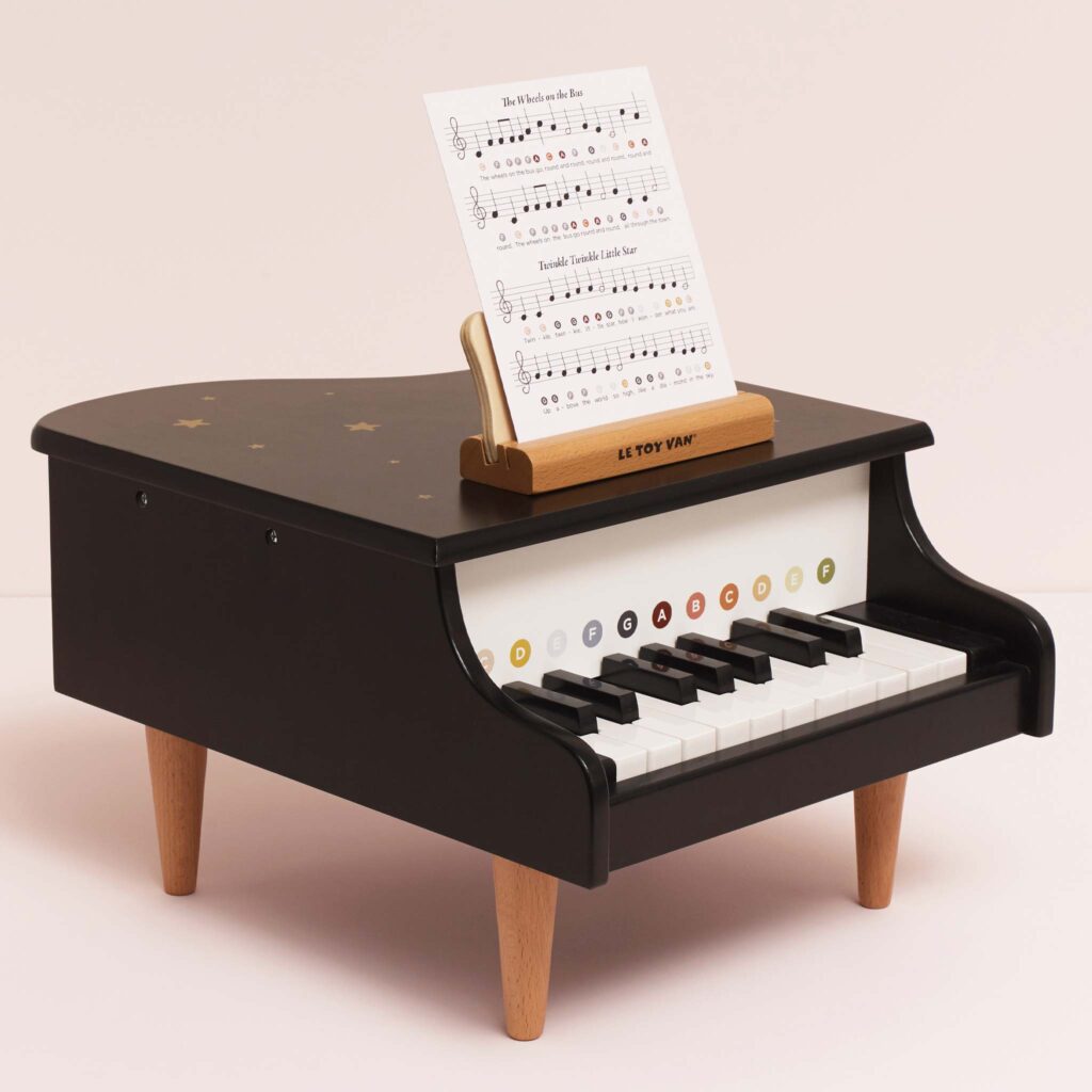 Junior Magazine A grand piano that will fit into the smallest of nurseries or playrooms. Inspire a love of music at an early age with this striking piece that comes with two double-sided music sheets, featuring eight popular nursery rhymes. The stand securely holds the sheets in place, making it easy for little hands to explore the joy of making a noise, we mean making sweet music!  A keepsake that will be treasured for years.