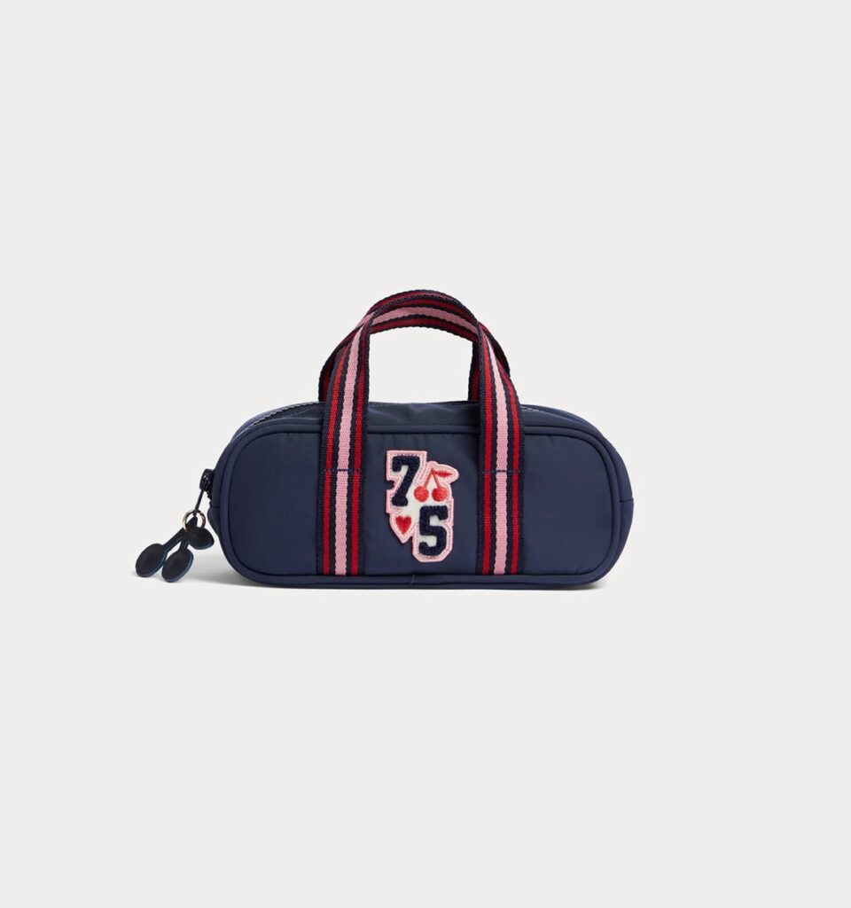 Junior Magazine A little touch of luxury for the school day, this soft bouclé pencil case with small handles and cherry details is a back to school essential that’s as stylish as it is practical.